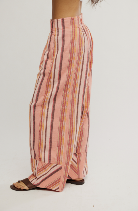 Striped pants worn by a person on a white background