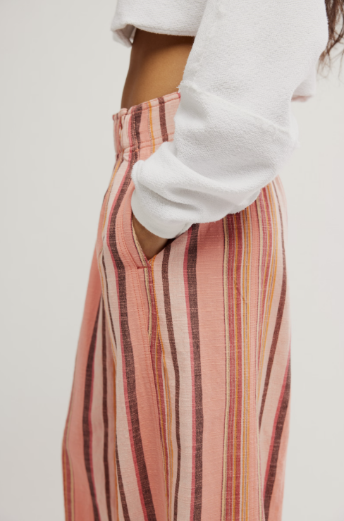 Woman wearing pink stripe pants on white background