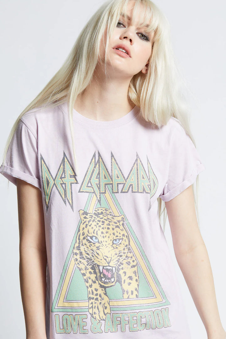 Person wearing a Def Leppard t-shirt with a leopard graphic on a white background