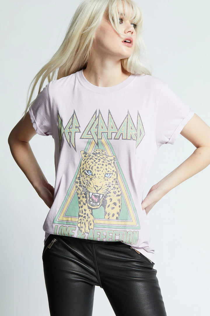 Person wearing a graphic t-shirt with a design on a plain background
