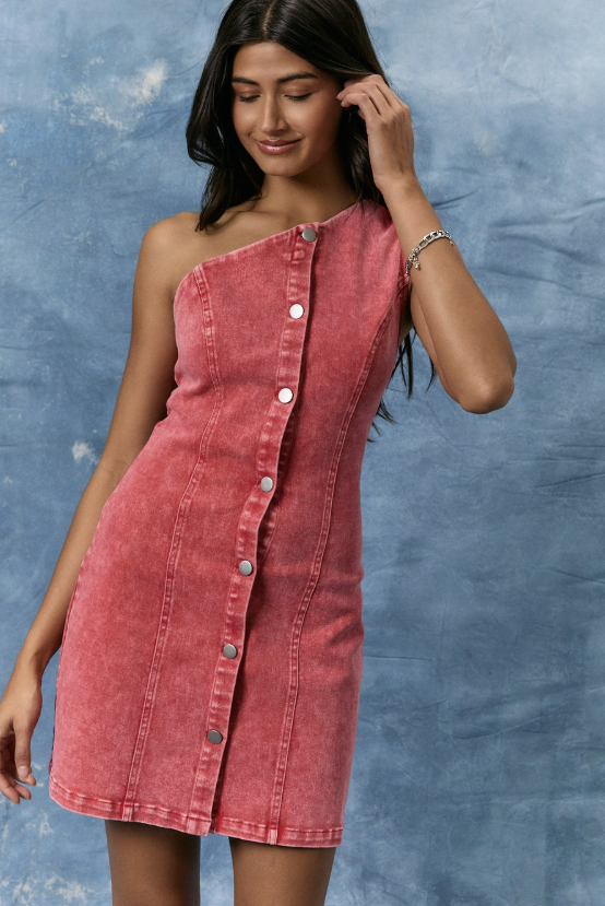 Woman wearing a red denim dress against a blue textured background