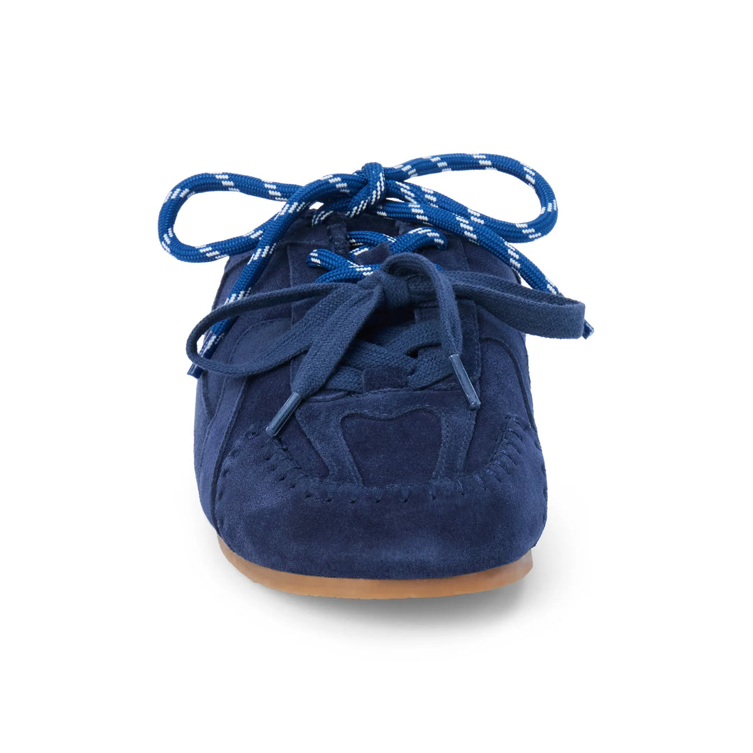 A single navy blue suede sneaker shown from a front-facing perspective on a clean white background. The shoe features matching navy blue laces with white speckles and a light brown gum outsole.