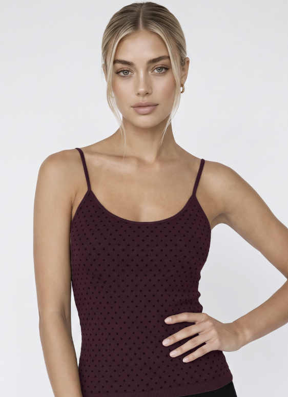 Woman wearing purple tank with black polka dots on white background