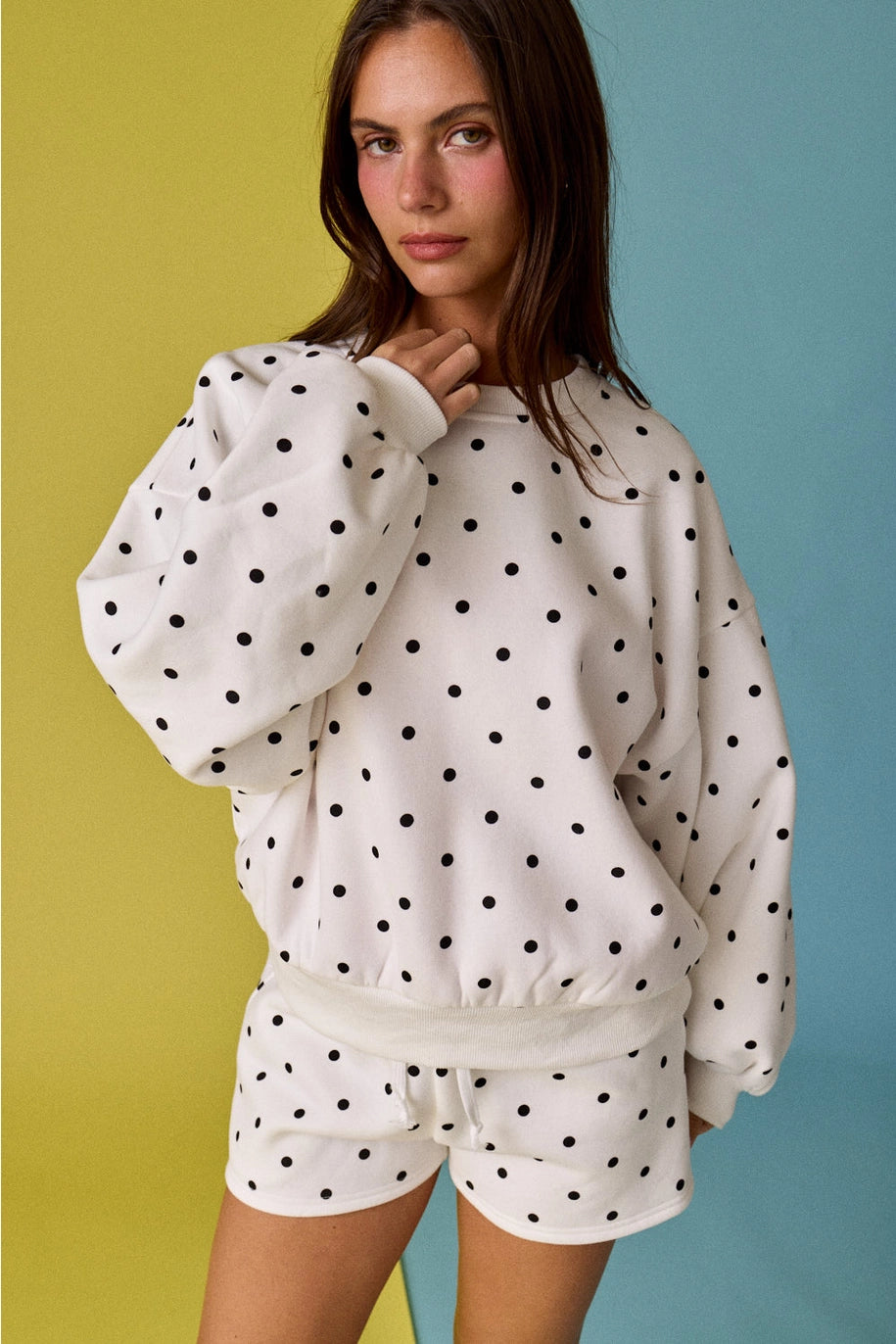 Woman wearing dot matching set on yellow and blue background