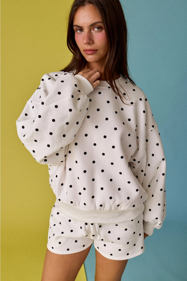 Woman wearing dot matching set on yellow and blue background