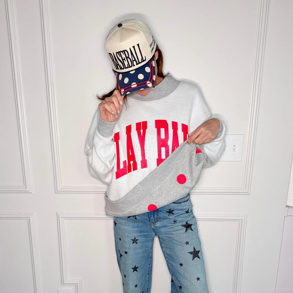 Woman wearing a reversible sweatshirt showing &
