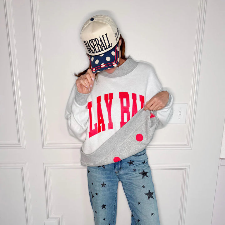 Woman wearing a reversible sweatshirt showing &