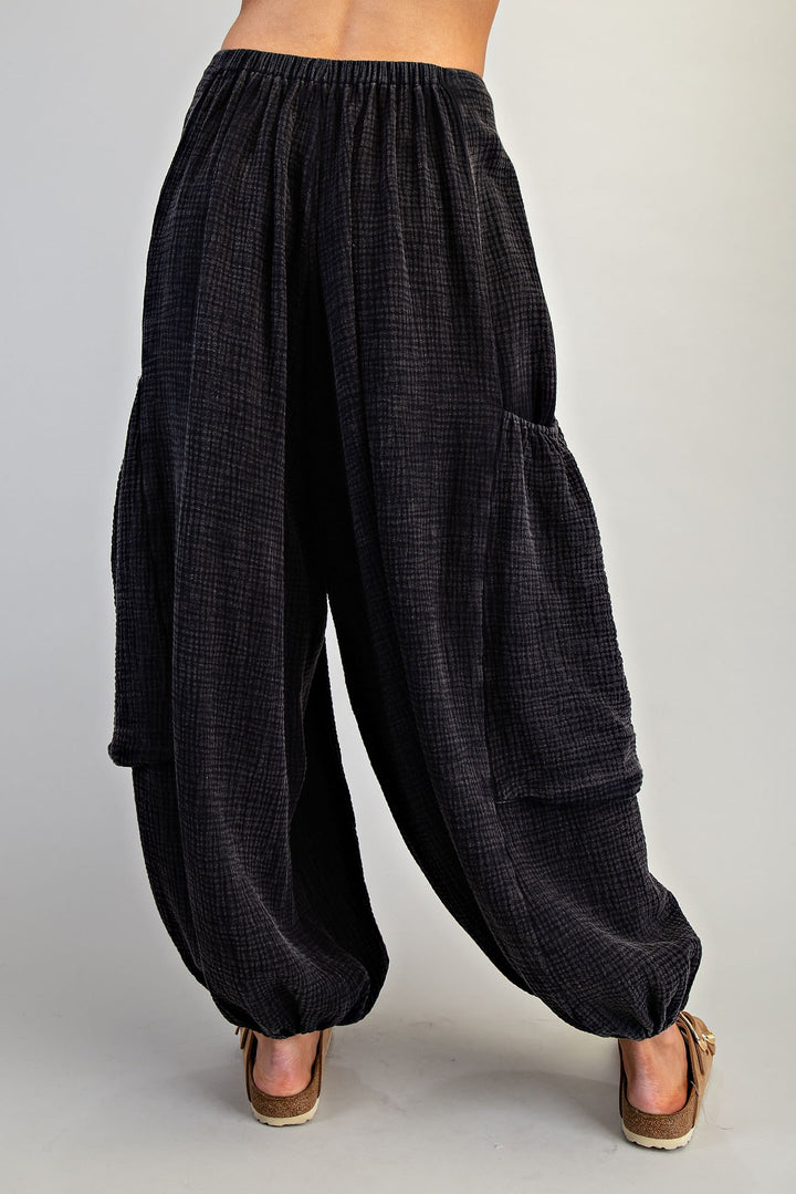 Black checkered wide-leg pants worn by a person on a plain background