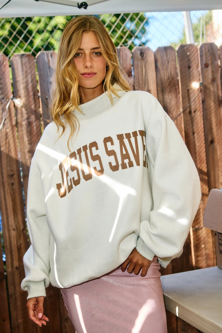 Woman wearing grey sweatshirt with &
