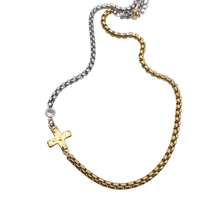 Gold and silver chain necklace with a cross pendant on a white background