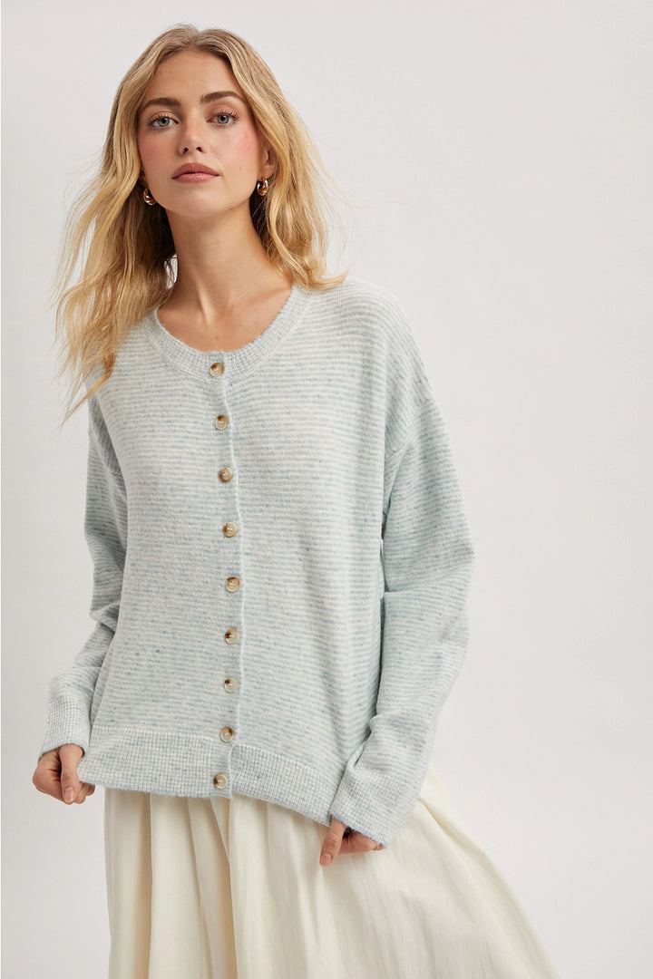Woman wearing a mint cardigan on a white background