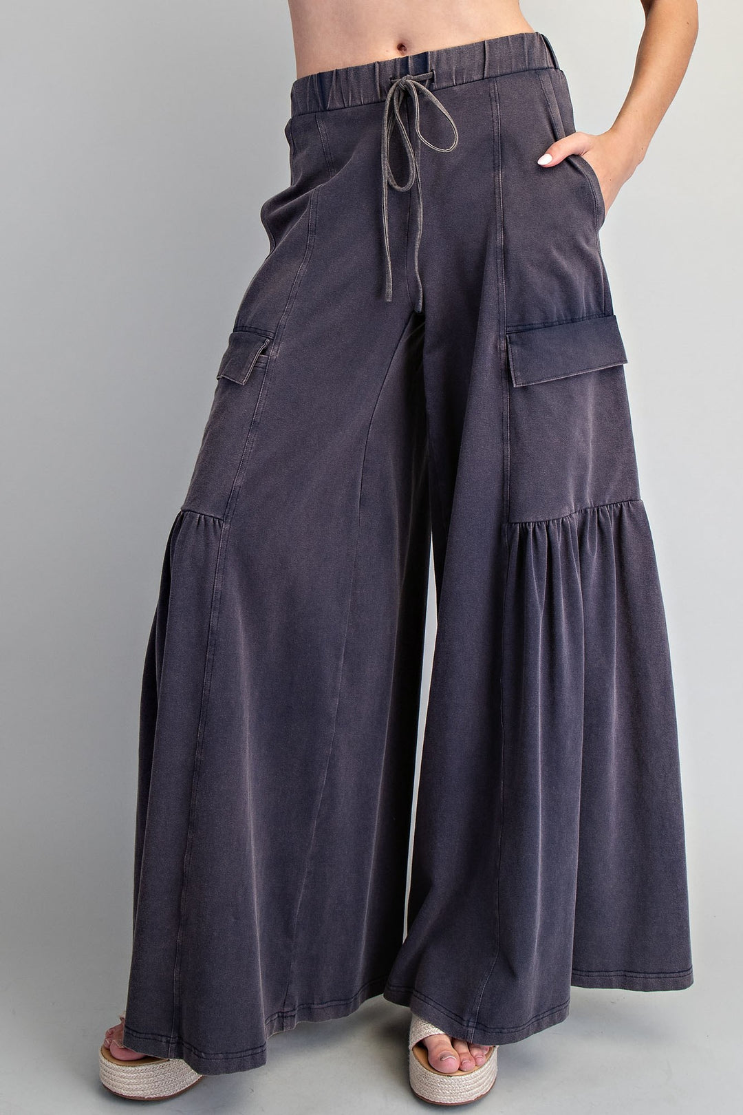Dark gray wide-leg pants with drawstring waist on a plain background