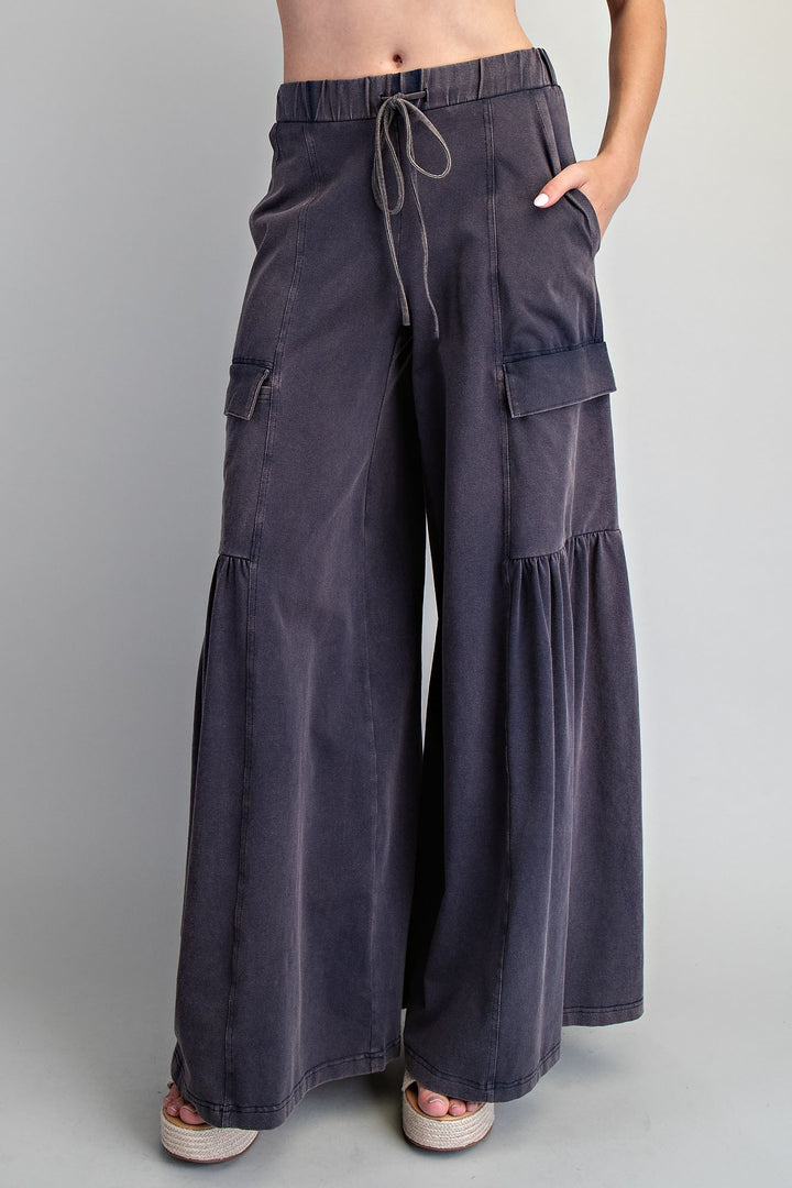 Dark gray wide-leg cargo pants worn by a person on a plain background