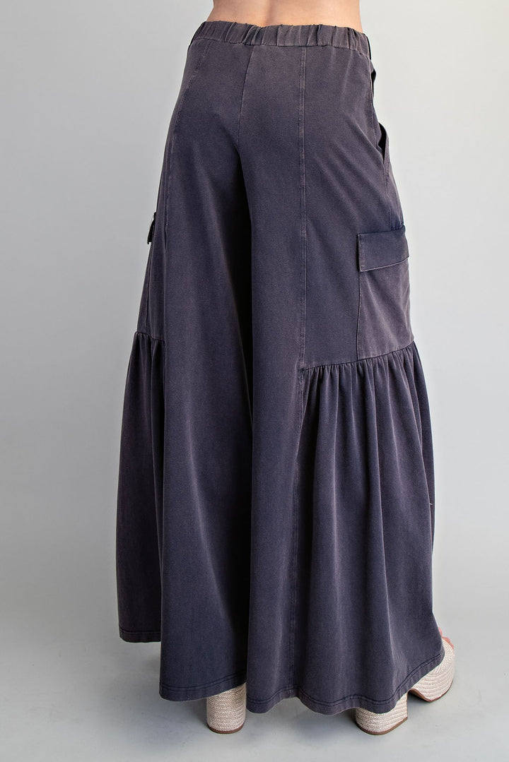 Dark gray wide-leg pants with pockets on a gray background