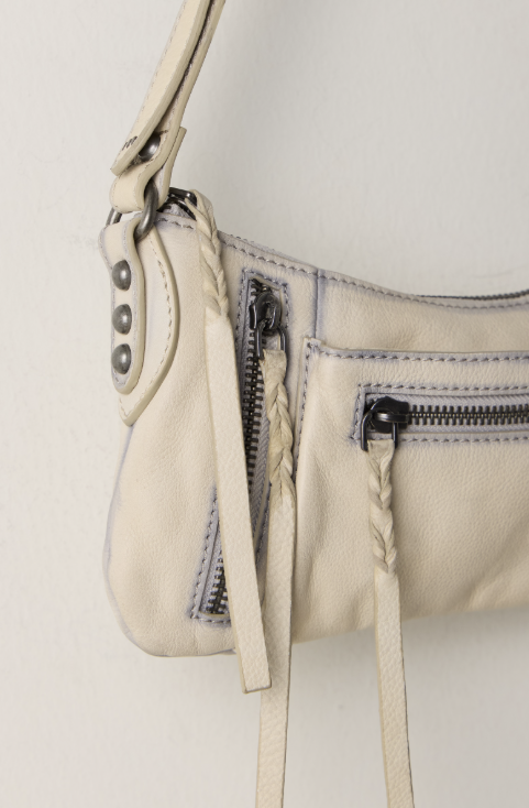 Small beige purse close up on white background