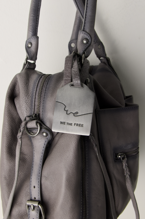 Close up of grey purse on beige background
