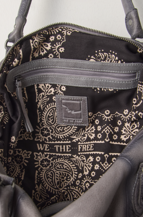 Close up of interior of purse with paisley print on beige background