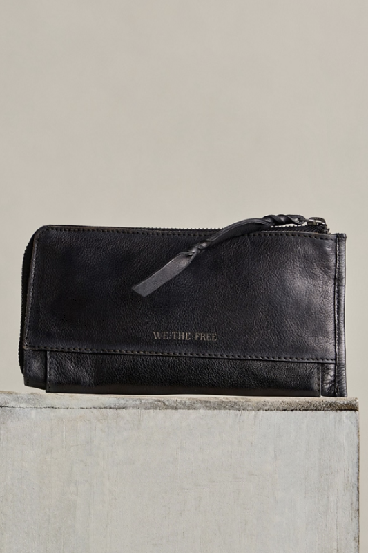 A black leather zip-around wallet with a braided leather pull tab and debossed &
