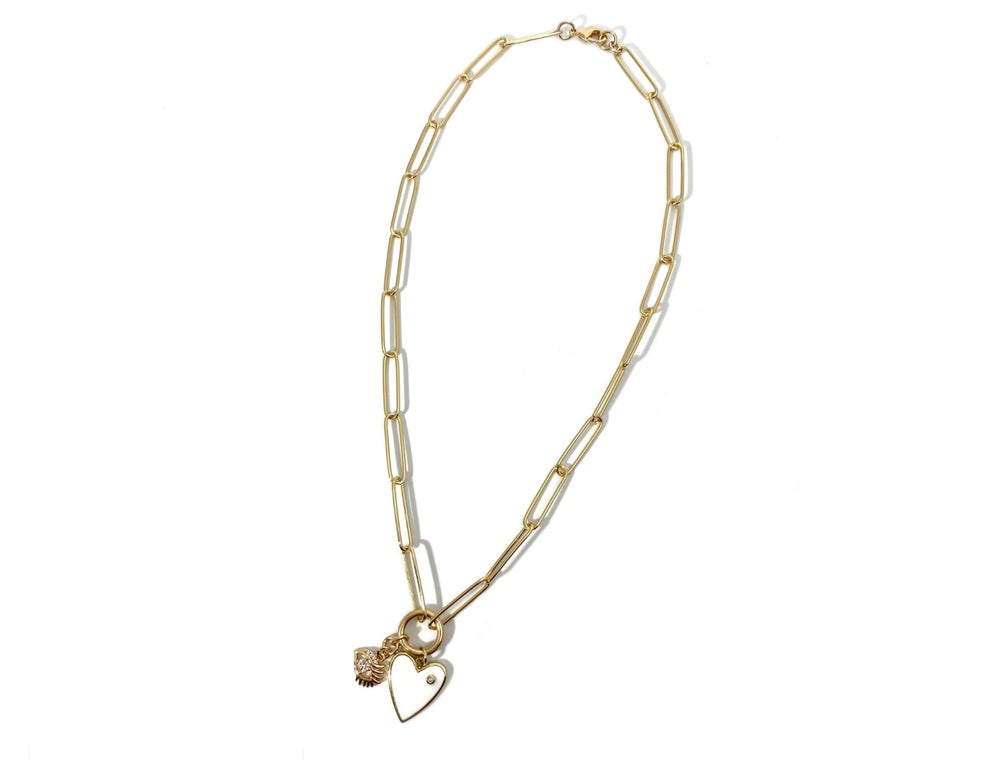 Gold necklace with a heart charm on a white background