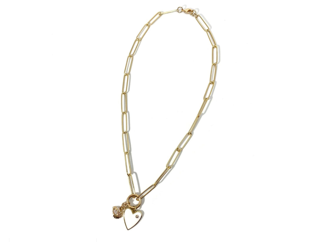 Gold necklace with a heart charm on a white background