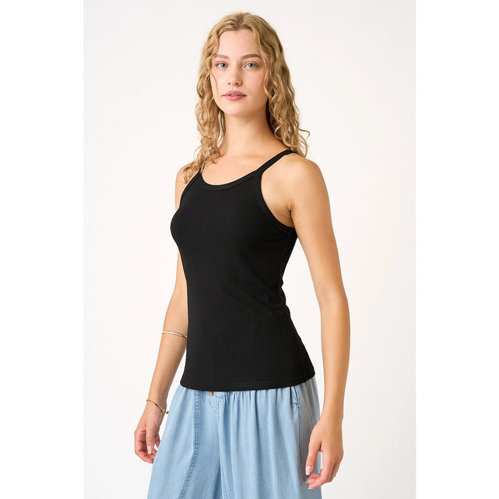 Woman wearing black tank on plain background