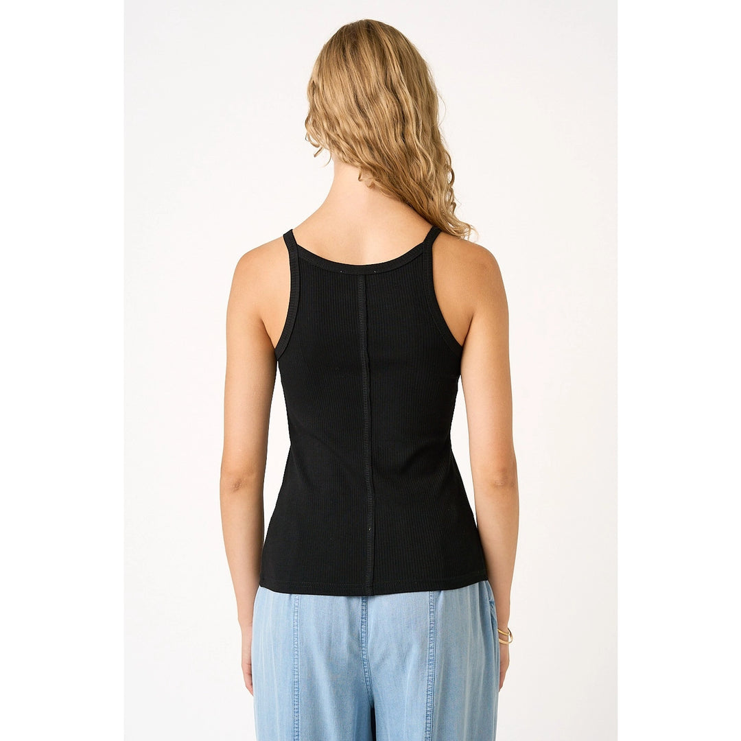 Woman wearing black tank on plain background