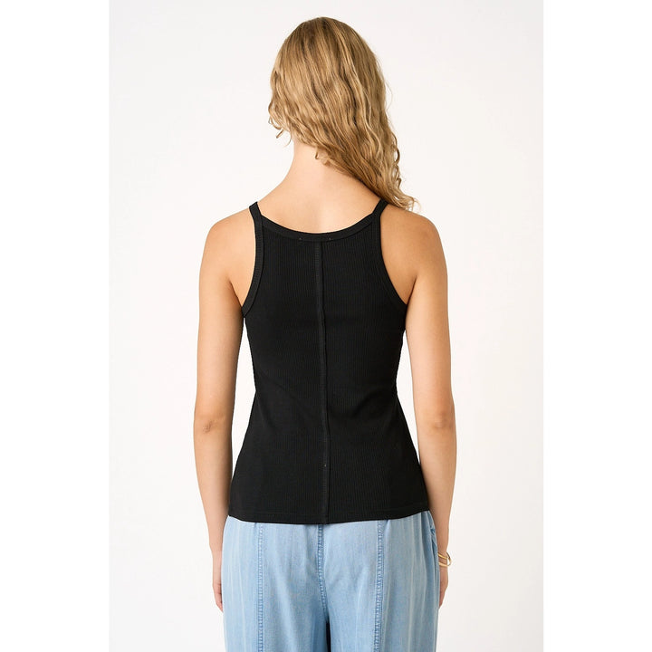 Woman wearing black tank on plain background