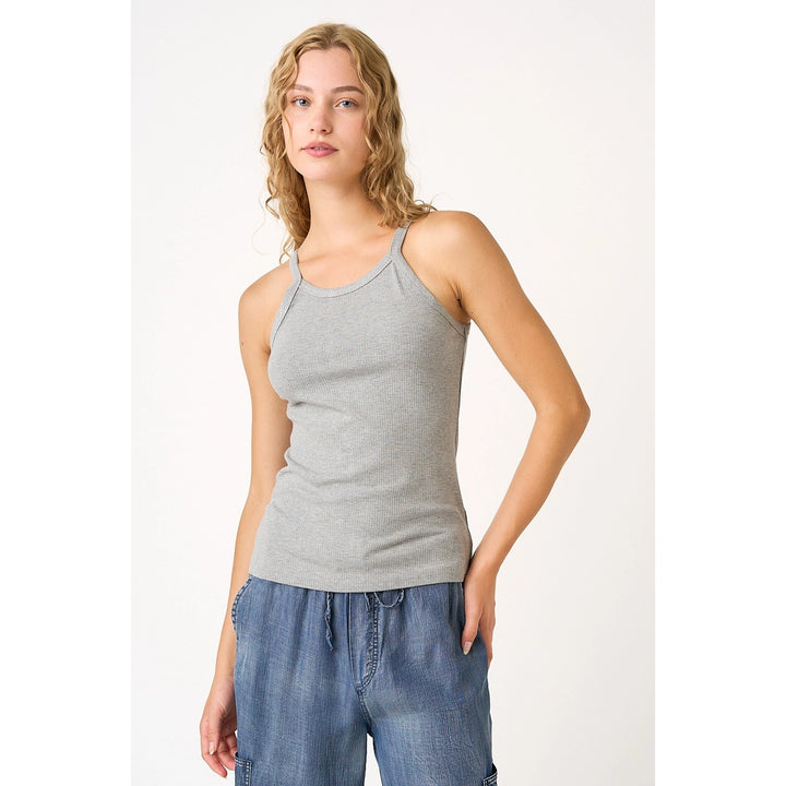 Woman wearing grey tank on plain background