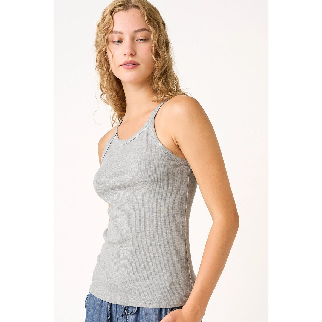 Woman wearing grey tank on plain background