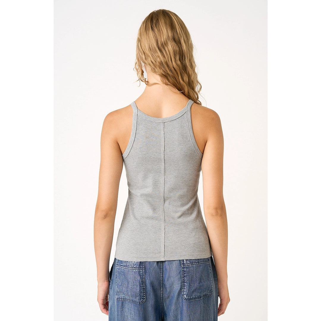 Woman wearing grey tank on plain background