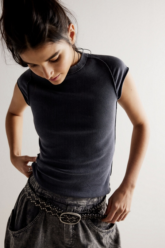 Woman wearing black tee and black pants on white background