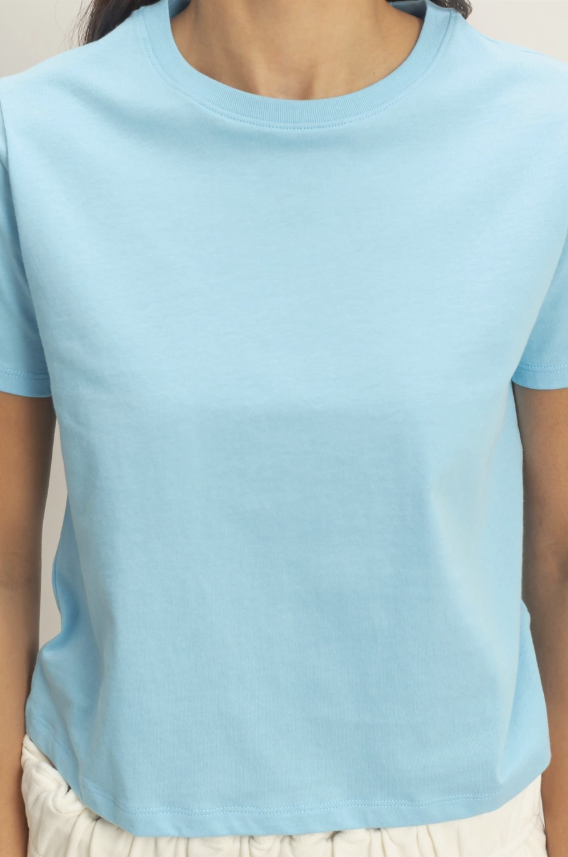 Light blue t-shirt worn by a person on a plain background