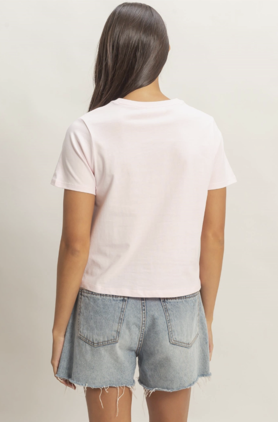 Person wearing a white t-shirt and denim shorts on a plain background