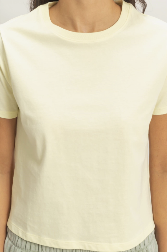 Light yellow t-shirt worn by a person, with a focus on the upper body.