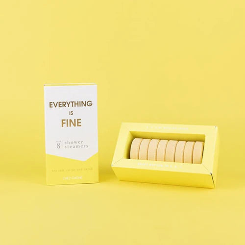 A boxed set of shower steamers on a solid yellow background. The packaging features a white and yellow box labeled &