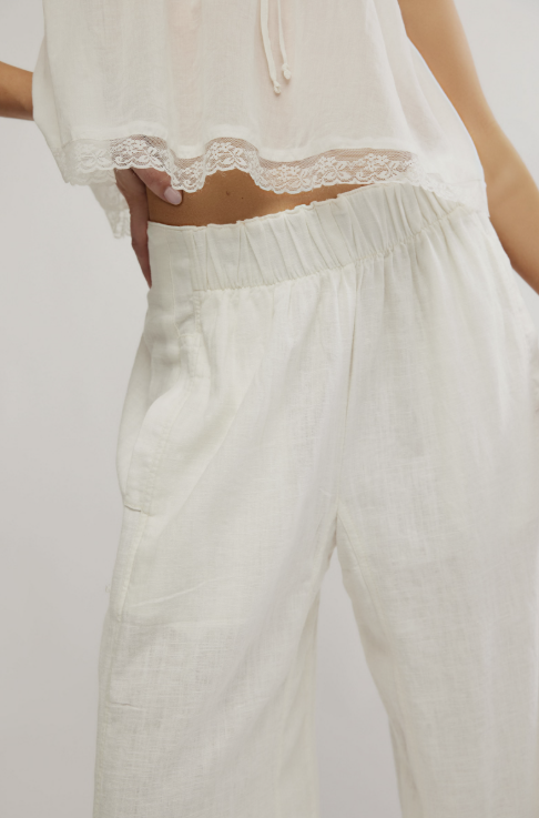 White lace-trimmed top and pants on a plain background