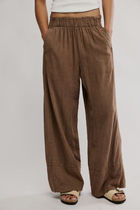 Brown wide-leg pants worn by a person on a plain background