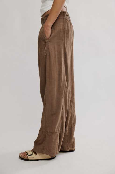 Brown wide-leg pants worn by a person on a plain background