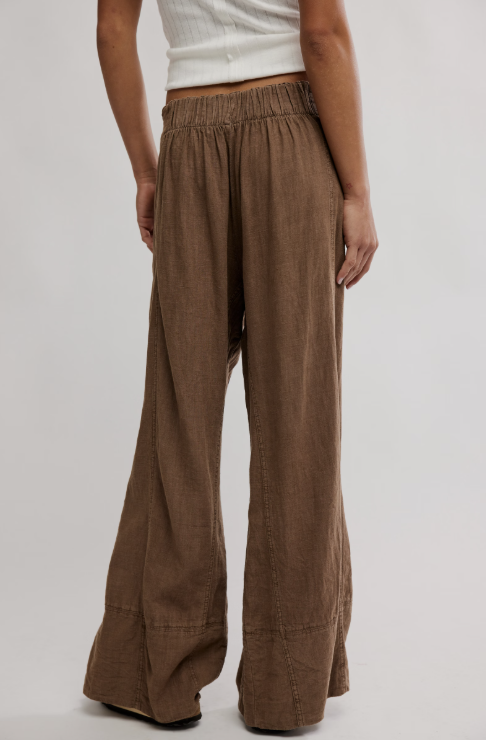 Brown wide-leg pants worn by a person on a plain background