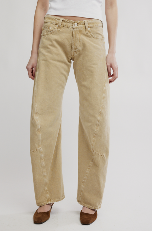 Beige jeans worn by a person on a white background