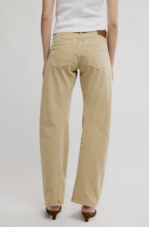 Beige pants worn by a person on a plain background