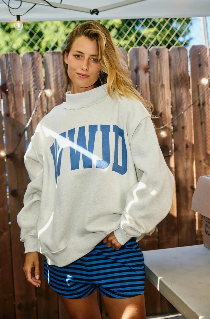 Woman wearing grey sweatshirt saying WWJD and striped shorts