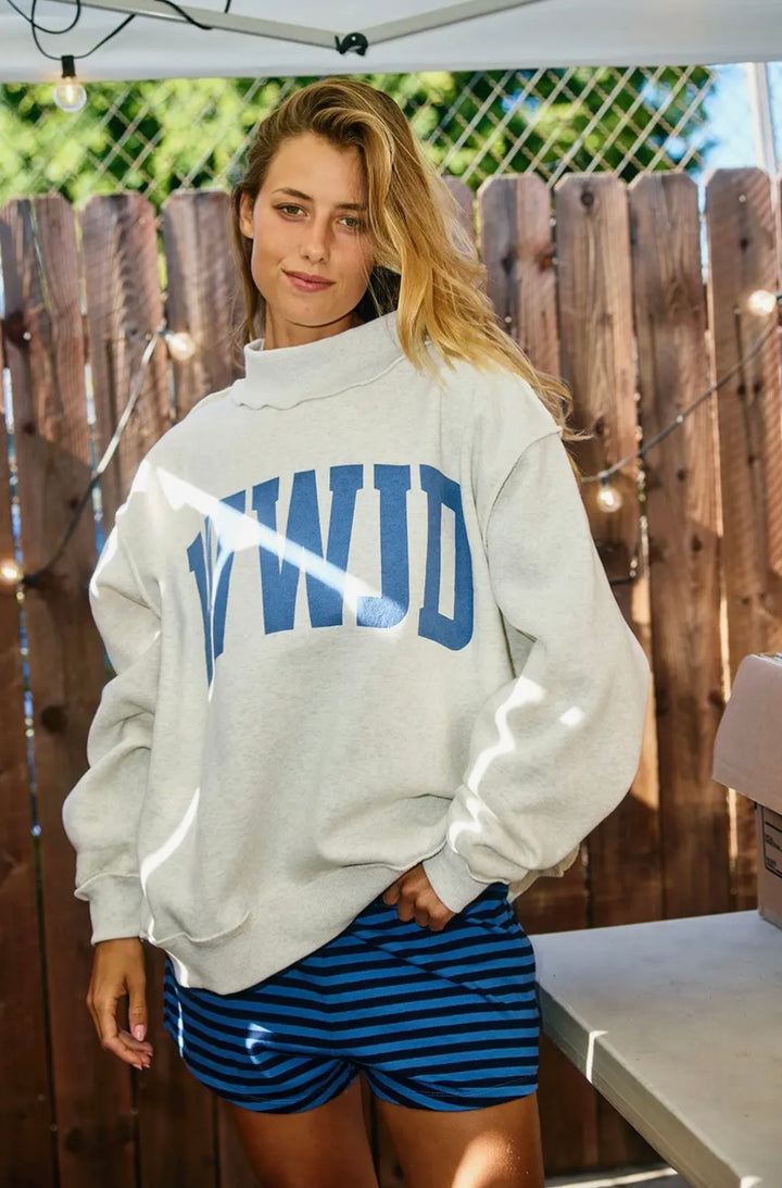 Woman wearing grey sweatshirt saying WWJD and striped shorts
