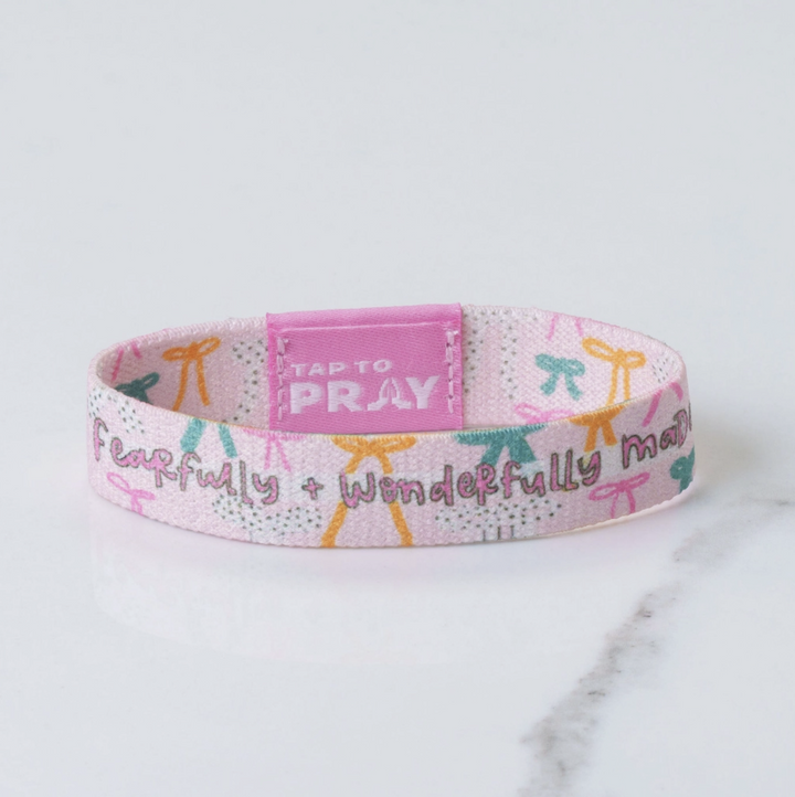 Wristband with motivational text on a marble surface