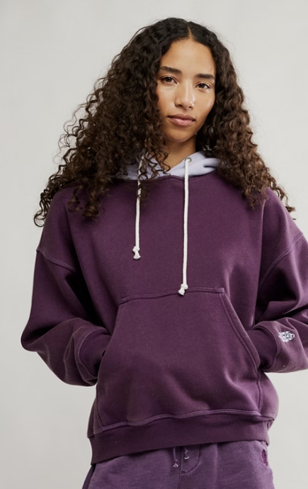 Woman wearing purple sweatshirt on white background