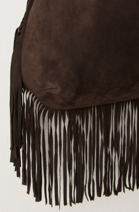 Brown suede bag with black and white fringe on a white background