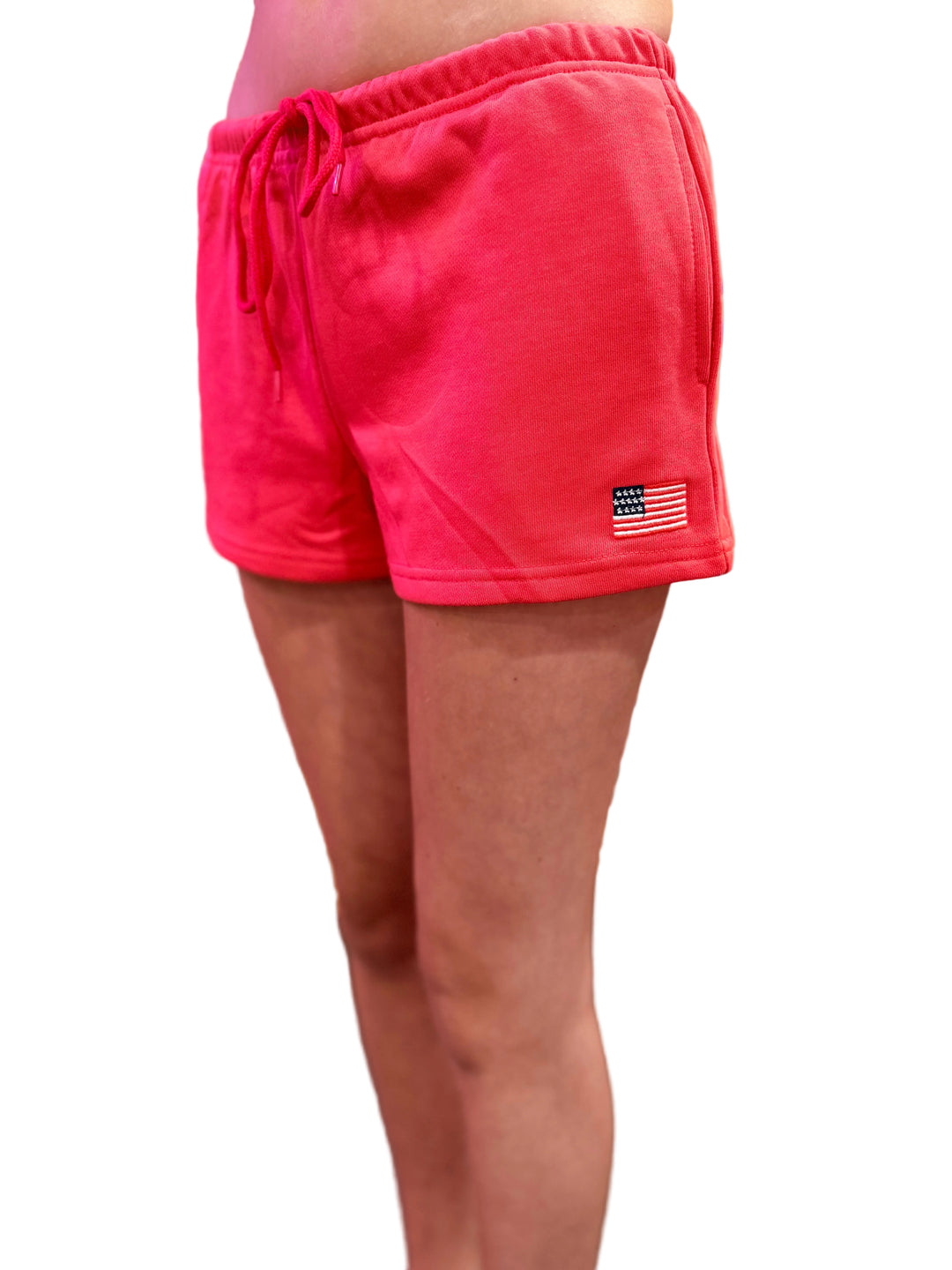 Red shorts with a small flag patch on a blurred background