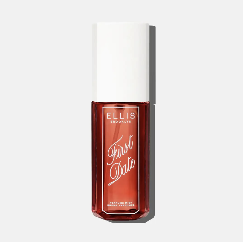 Ellis Brooklyn First Date perfume in a clear rectangular bottle showing a deep warm red color, topped with a white cap, on a light gray background.