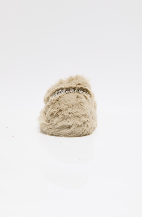 A single beige faux fur slipper with a decorative band of small rhinestones across the top, photographed against a seamless white background.