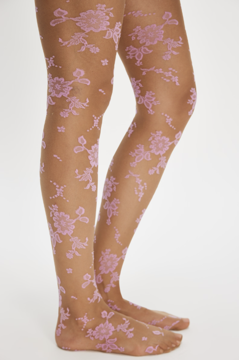 Woman wearing pink flocked floral tights on white background